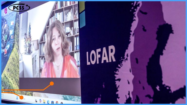 The graphic shows two main screens. On the left screen, a video conference with a woman speaking is displayed. Behind her, in the background, there is a bookshelf. The right screen features a large "LOFAR" inscription and a map or land contour in shades of purple. In the lower part of the left screen, fragments of the operating system's taskbar and an orange, curved graphic line are visible.
