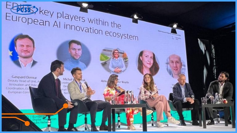 The photo captures a panel discussion at a conference, likely related to digital innovations. In the foreground, six individuals are seated around a table, actively engaged in conversation. Behind them, a large screen displays the text "key players within the European AI innovation ecosystem," along with portraits and names of the panelists. In the background, "EDIH Network Regional Conference" signage is visible.