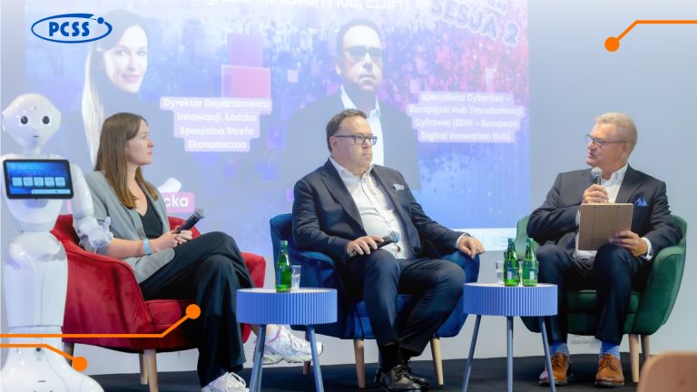 Query successful A medium shot captures three panelists and a white robot on a stage during a "Nowa Era Innowacji – Transformacja Cyfrowa" (New Era of Innovation – Digital Transformation) event. Two men sit on blue armchairs on the right, facing a woman seated on a red armchair to the left. The robot stands to the far left of the panel, with a screen on its chest displaying a blue interface.